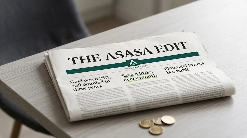 The Asasa Edit, Issue 1, folded on a table beside a few coins